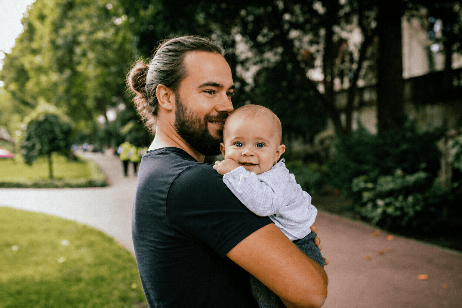 A father holding his baby outdoors