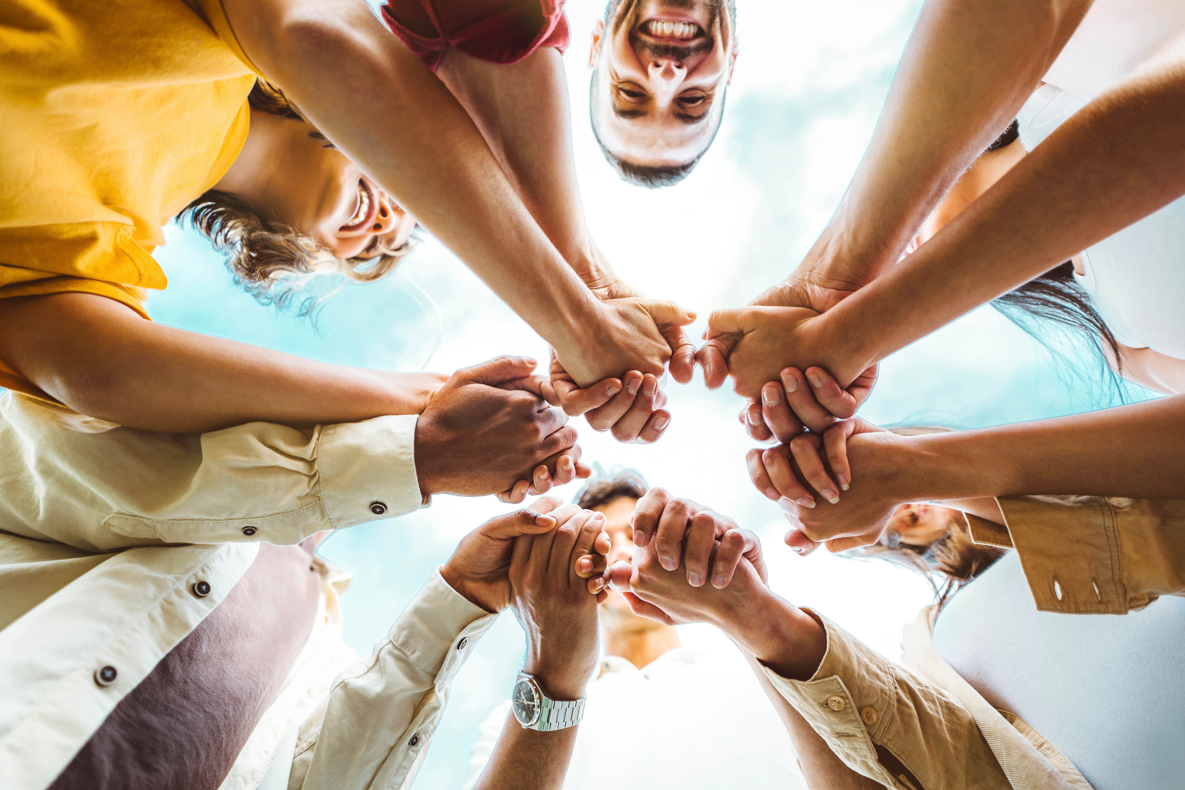 A supportive group holding hands together